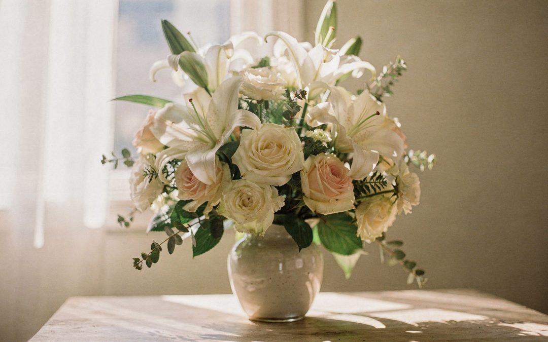 Sympathy flowers San Diego white lily and rose arrangement in soft window light