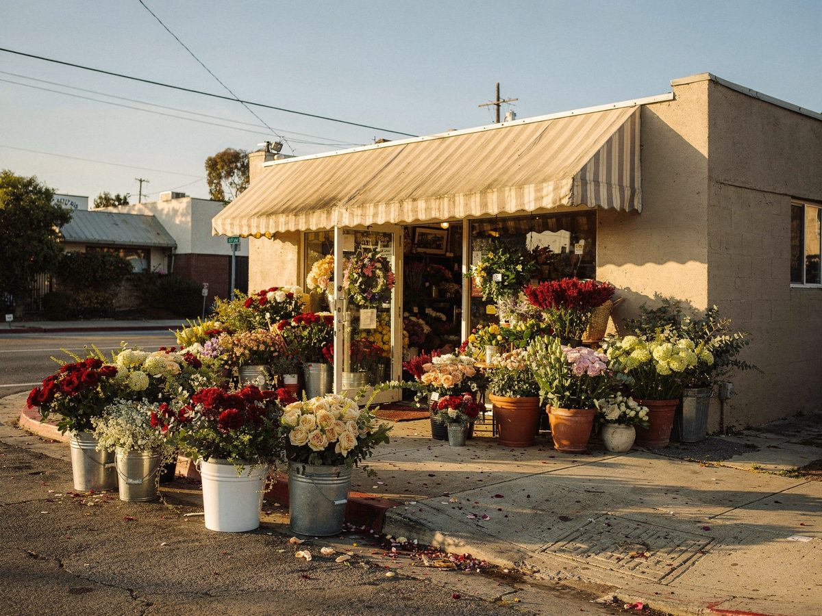 Storefront of a family-owned San Diego flower shop with buckets of fresh flowers on the sidewalk